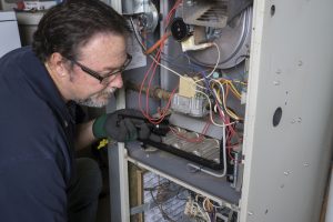 technician-inspecting-furnace